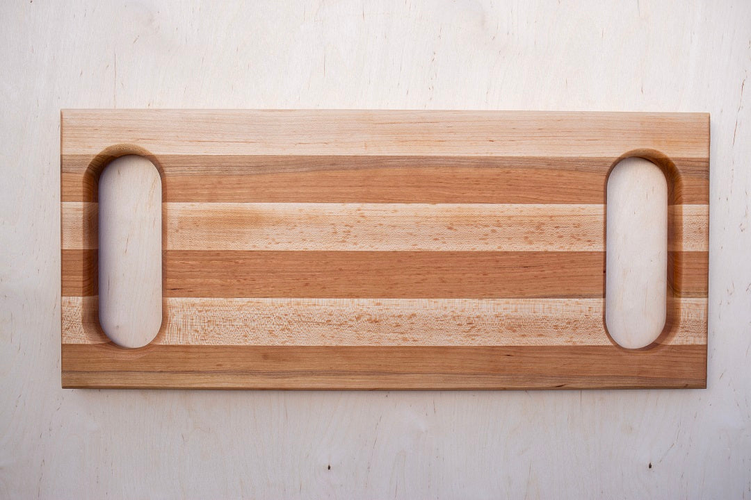 10x23x1.5”- Edge grain cherry and maple with handles routed into each end