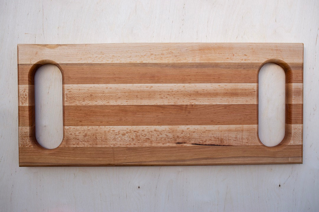 10x23x1.5” Edge grain cherry and maple with handles routed into each end