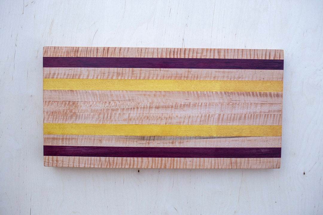 8.5x16.5x1.25- Edge grain curly maple, yellow heart, purple heart